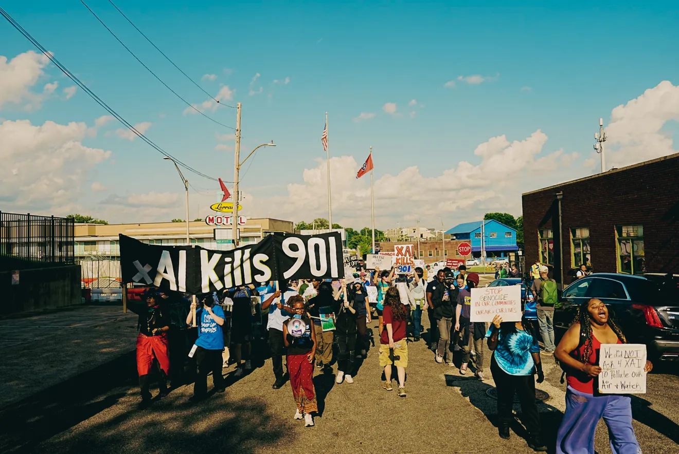 Protesters march through Memphis holding a banner reading 'xAI Kills 901'